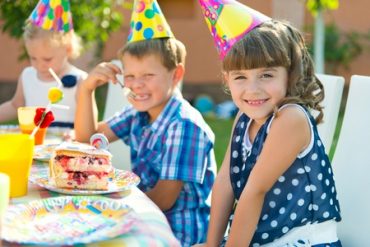 Children Eating Cake at Party