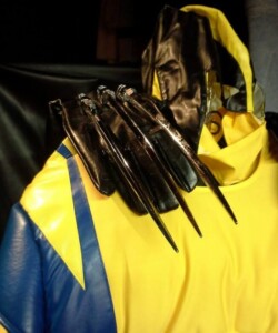 Yellow and blue costume with silver claws on the shoulder, resembling a superhero outfit.