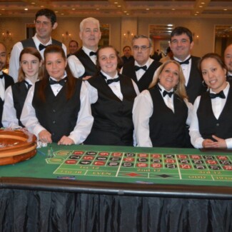 casino workers behind a Roulette table