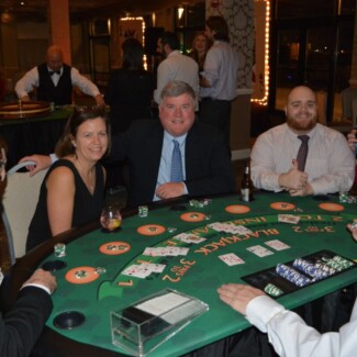group of people around poker table gambling